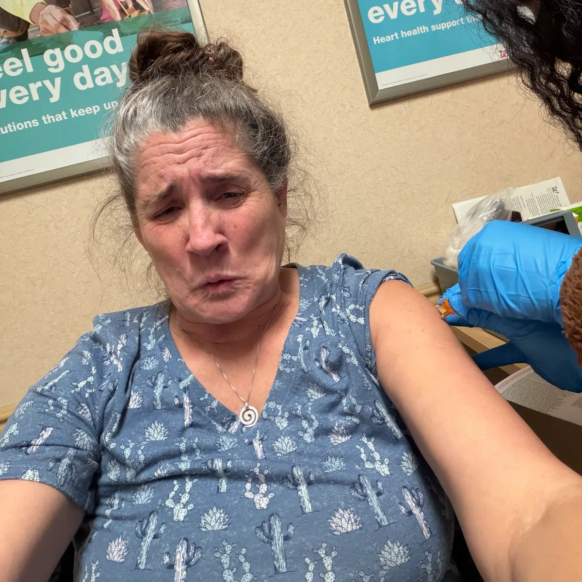 Jolynn making a nervous face while getting a shot in her arm.